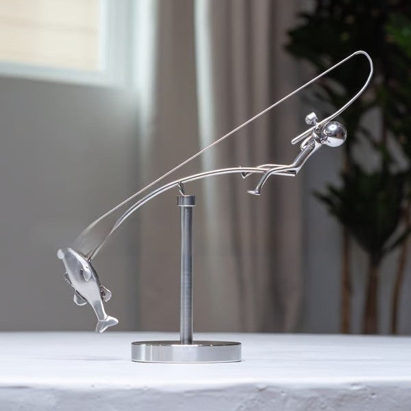 balanced fisherman sculpture