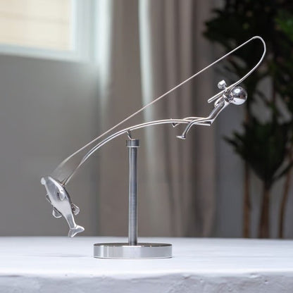 balanced fisherman sculpture