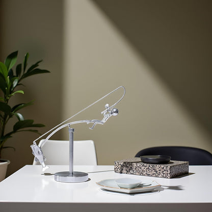 balanced fisherman sculpture