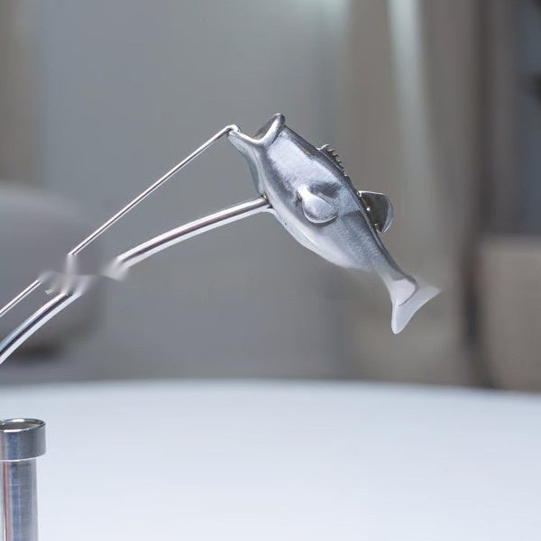 balanced fisherman sculpture